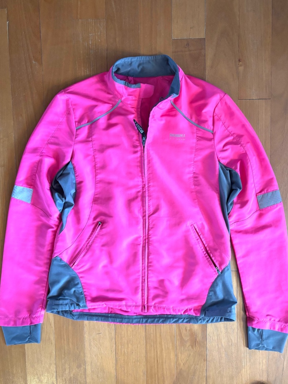 Running Room three pocket reflective ladies running jacket. Size M